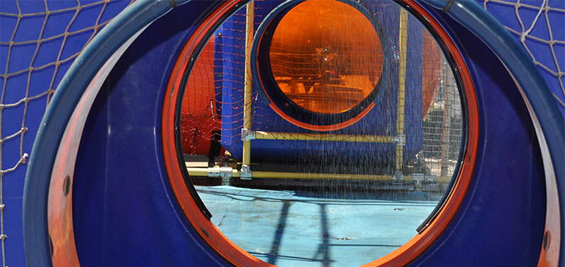Image looking through the Kid Wash, a water attraction that simulates a car wash. The kid wash is blue and orange.
