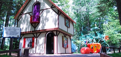 Image of Story Book Lane. The image shoes Cinderellas house with her pumpkin carriage in the background.