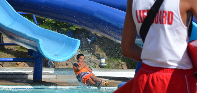 Image of a lifeguard facing a boy going into the water