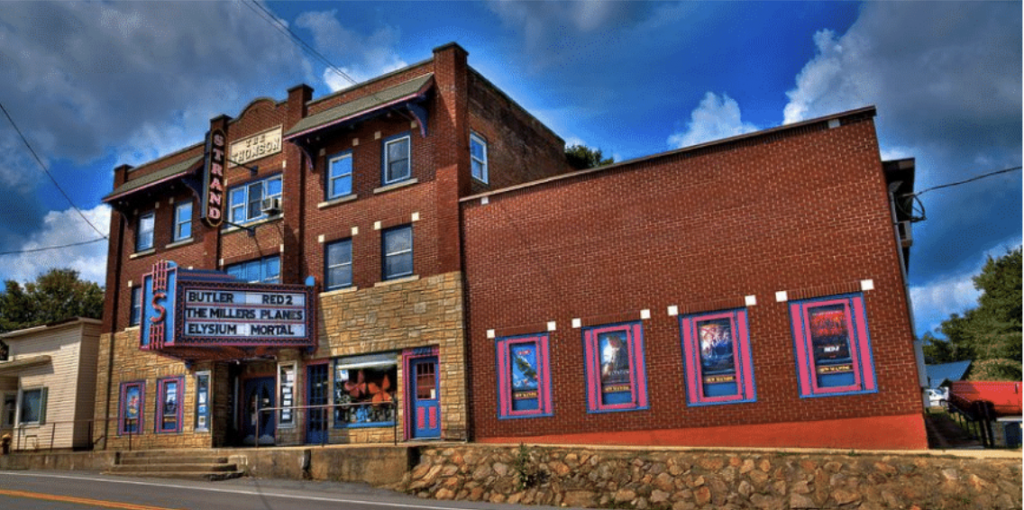 The outside of an old brick building that is the strand theater 