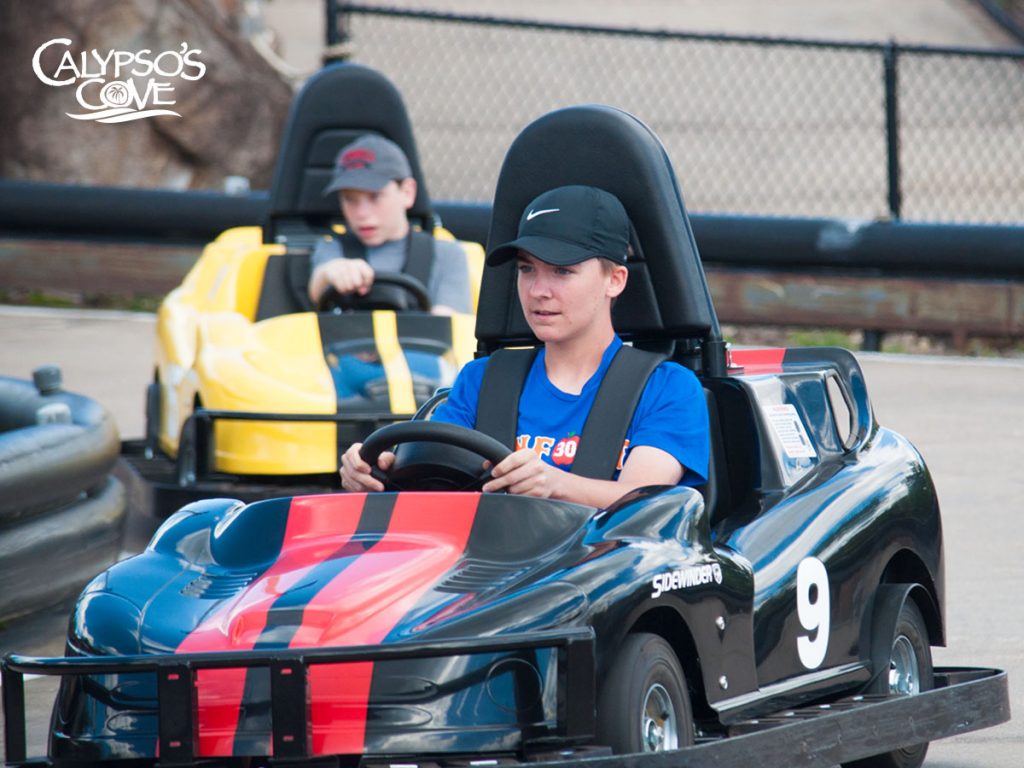 Two boys riding the go-karts at Calypso's Cove.